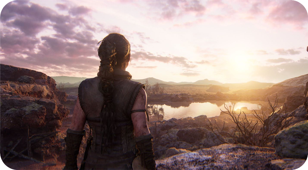 Senua overlooking a rocky landscape at sunset in Hellblade II.