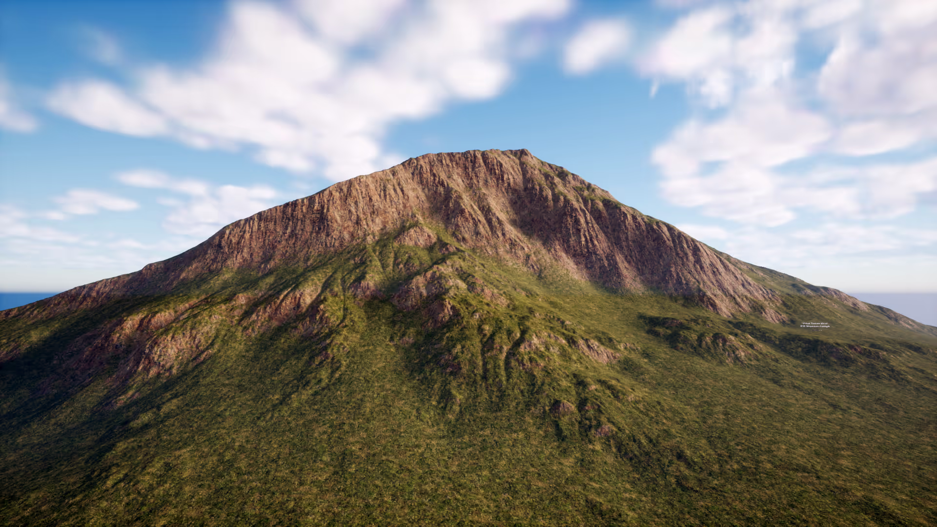 A grassy mountain landscape beneath a partly cloudy sky.